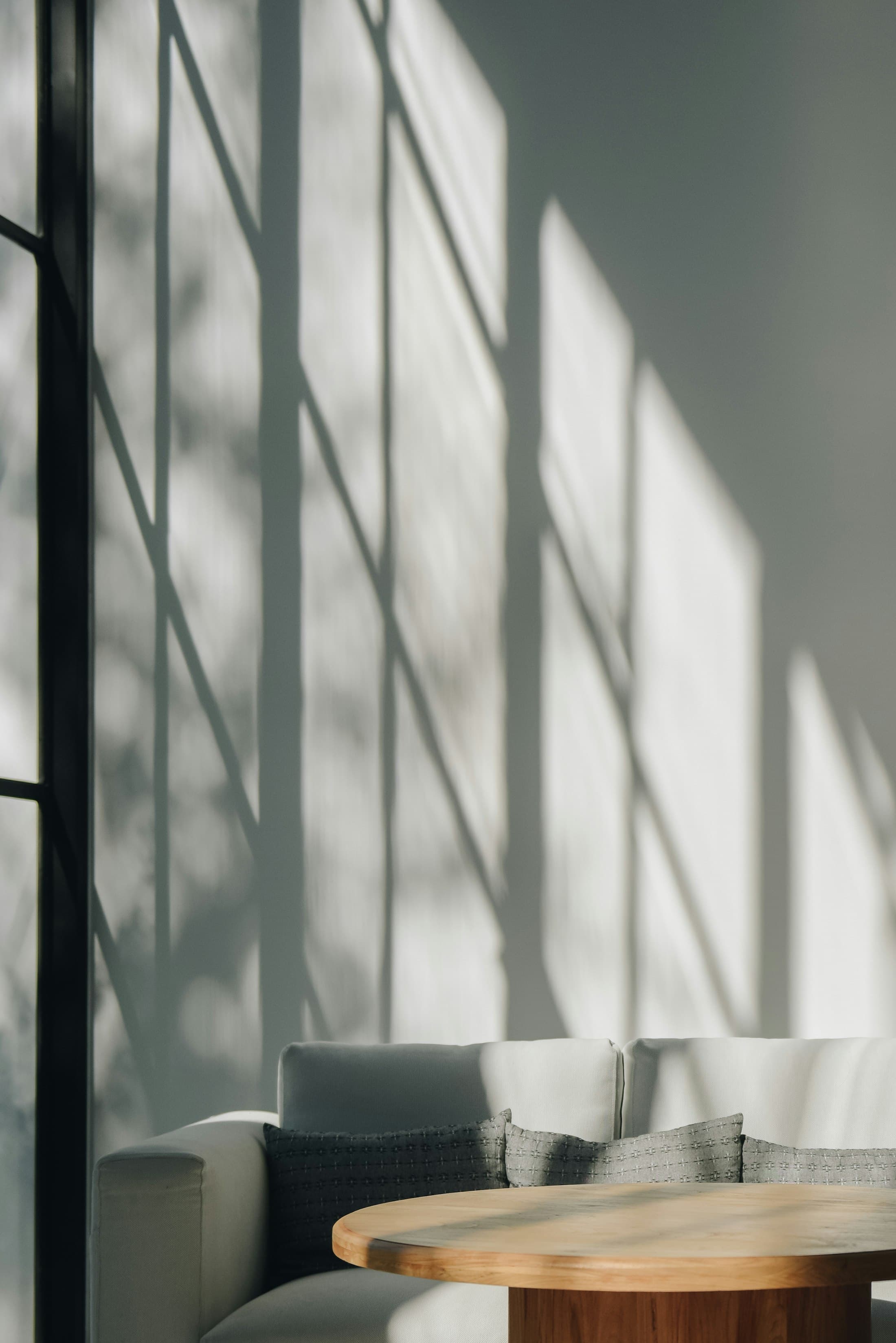 Afternoon light and shadow across a quiet living room