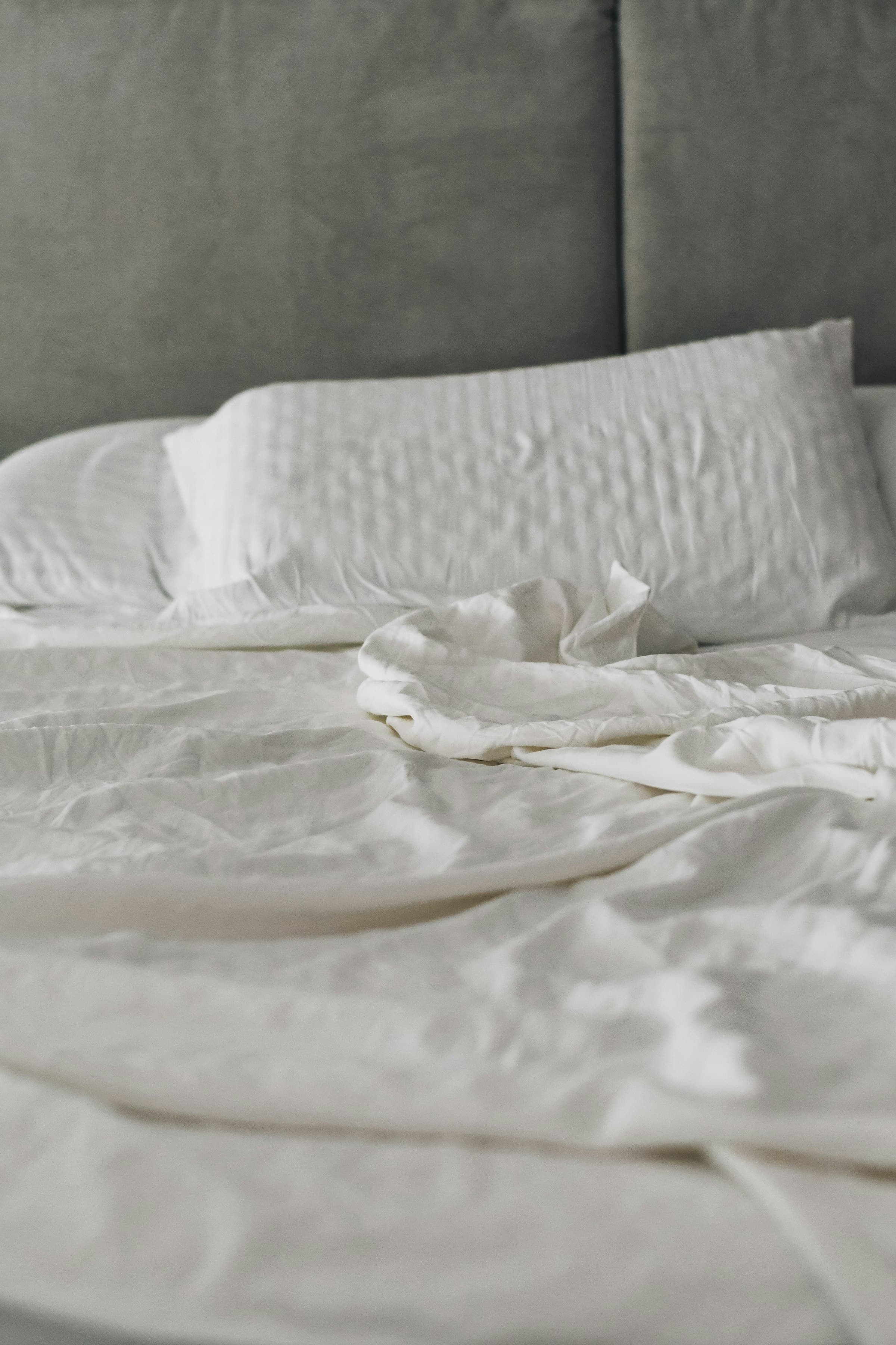 Soft, sunlit linens in a quiet bedroom moment